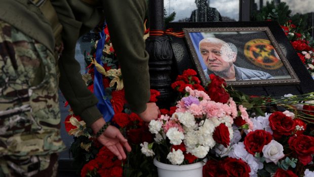 Muž pokládá květiny k provizornímu památníku Jevgenije Prigožina, šéfa žoldnéřské skupiny Wagner, když si připomíná 40 dní od jeho smrti, aby dodržel pravoslavnou tradici, na ulici v Petrohradě