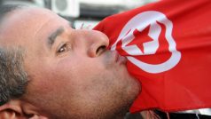 demonstrant líbá tuniskou vlajku