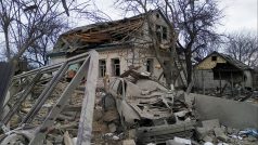 Zničené auto a zničený dům po ostřelování v obci Marhalivka v Kyjevské oblasti
