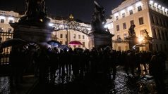 Před půlnocí se v nepříznivém počasí na Hradčanském náměstí sešlo několik desítek lidí ...