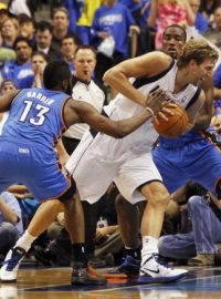 Dallas Mavericks forward Dirk Nowitzki  (C) is defended by Oklahoma City Thunder guard James Harden (L) and forward Serge Ibaka during the second half of their NBA Western Conference quarter-final playoff basketball game in Dallas, Texas May 5, 2012