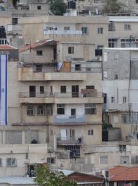 Židé si na domech, které v arabské čtvrti získali, vyvěšují izraelské vlajky
