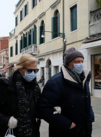 Dvojice s rouškou v ulicích italských Benátek.
