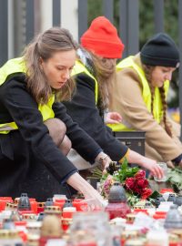 Studenti sbírají svíčky, květiny a další předměty z pietního místa u Karolina